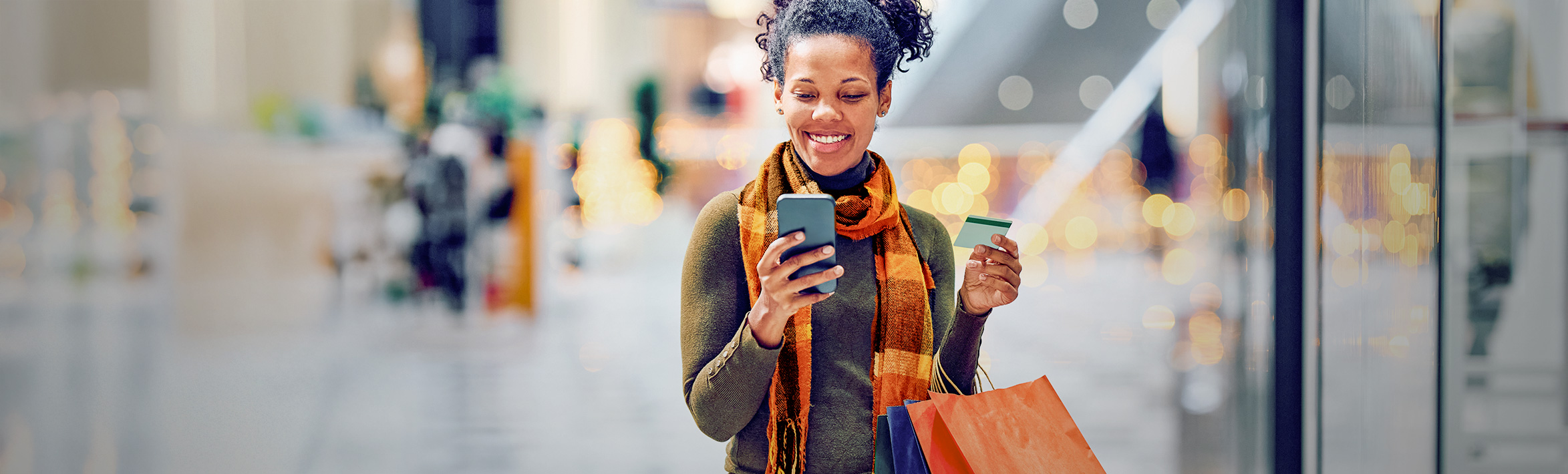 An adult smiling and looking away from the camera.